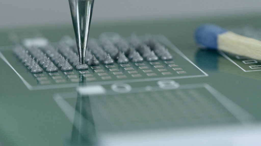 eco-PEN microdispensing silver conductive paste on print card compared to match to show micro size